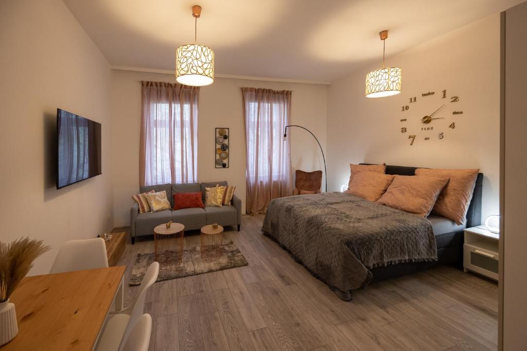 a bedroom with a bed and a couch and a table at Central Apartments Vienna in Vienna