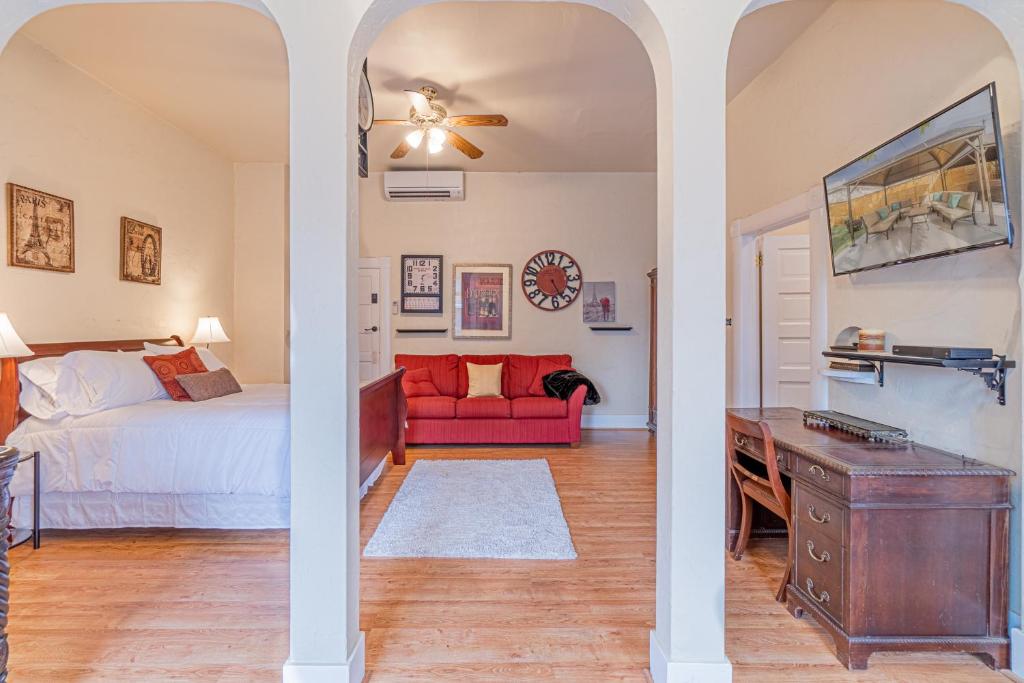 a bedroom with a bed and a red couch at Rustic Studio walking distance to Downtown in Reno