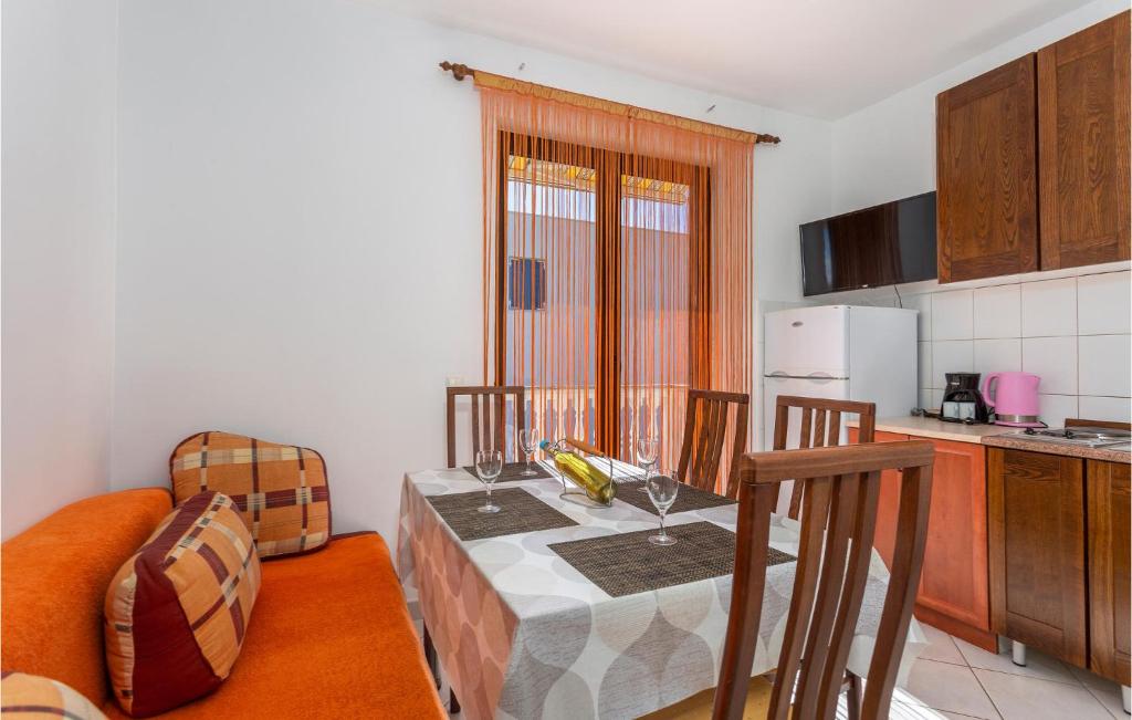 kuchnia ze stołem z 2 krzesłami oraz kuchnia z tableablish w obiekcie Cozy Apartment In Jurandvor w mieście Jurandvor