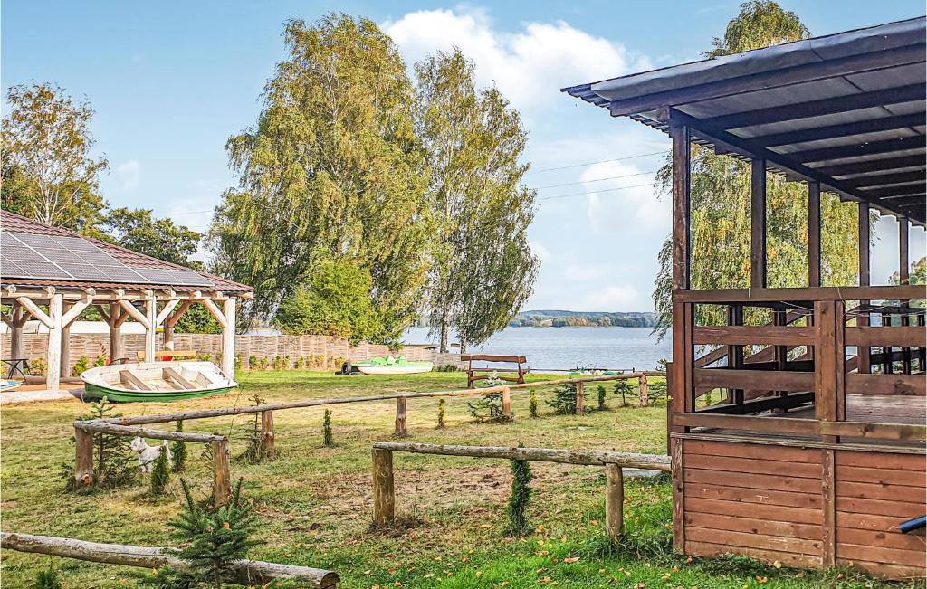 a pavilion and a gazebo next to a lake at Awesome Home In Biskupiec With 2 Bedrooms in Biskupiec