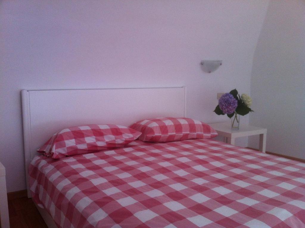 a bedroom with a checkered bed with two pillows at Palazzo Damelio in Scala