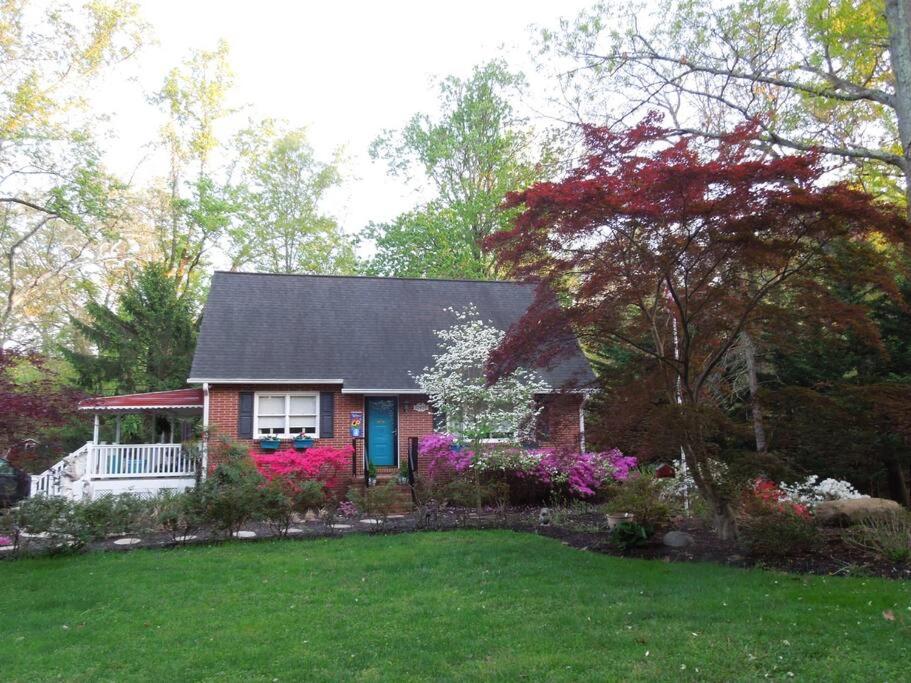 a small house with flowers in a yard at Relax in Nature & Serenity at Bird River Cottage! in Middle River