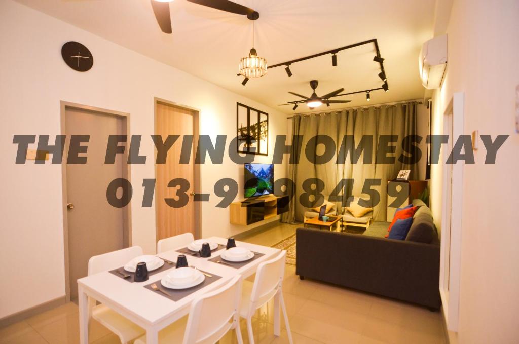 ein Wohnzimmer mit einem weißen Tisch und einem Sofa in der Unterkunft The Flying Homestay Terengganu in Kuala Terengganu