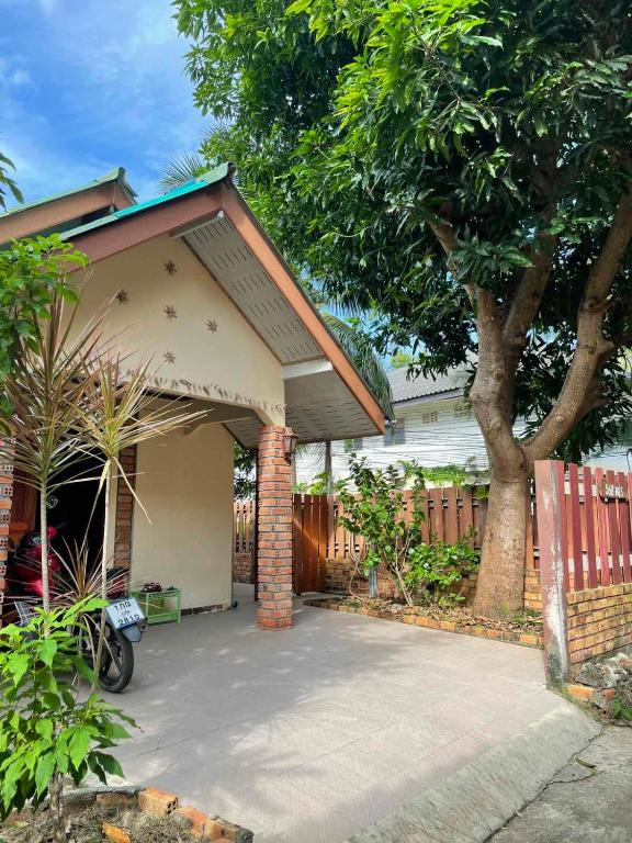 a house with a garage with a tree at Mango House in Ko Lanta