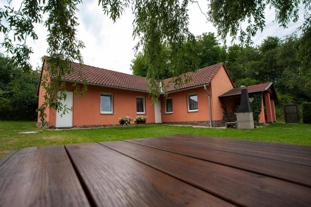 ein Haus mit einer Holzterrasse davor in der Unterkunft Penzion Lukov in Lukov