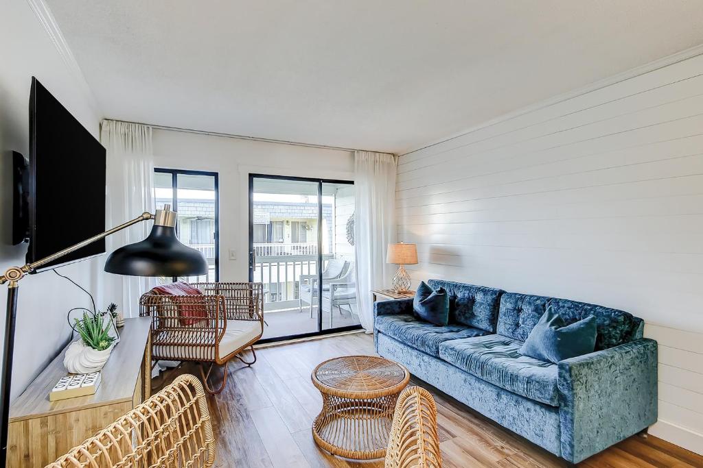 a living room with a blue couch and chairs at Oceanside 308-B in Isle of Palms