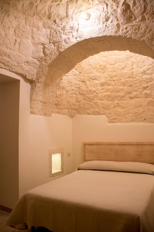 A bed or beds in a room at I trulli di Nonno Battista