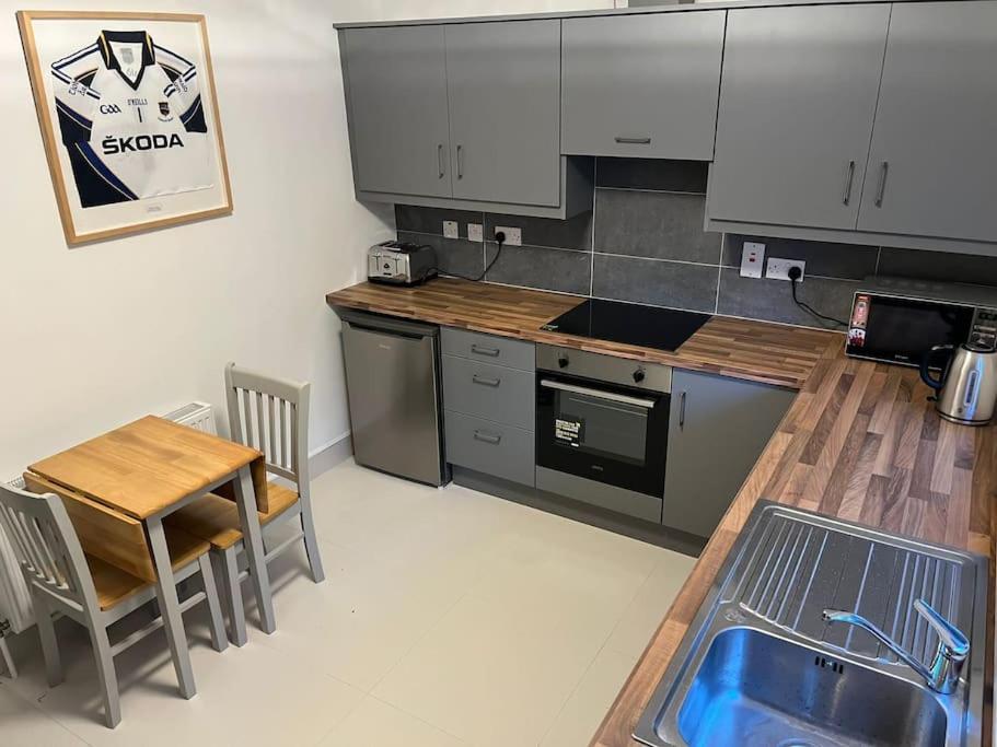 a kitchen with a counter and a table and a table and chairs at Glencree Air in Kilmeaden