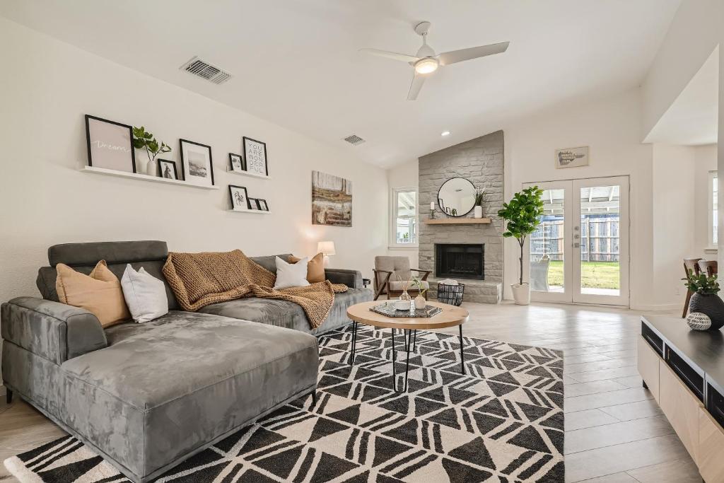 a living room with a couch and a table at Cozy Stylish Home in Round Rock! in Round Rock