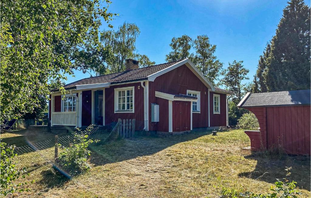 a small red house in a yard at Gorgeous Home In lem With Wifi in Ålem
