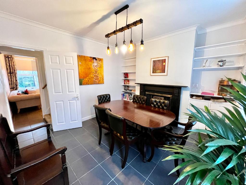 a dining room with a table and a fireplace at The secret garden house in Lincolnshire