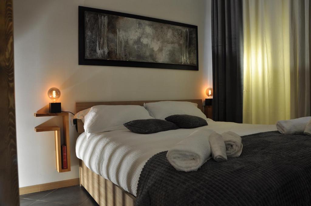 a bedroom with a bed with two pillows on it at C Studio - Design Bilo Suite -M3- 8 min dal Duomo in Milan