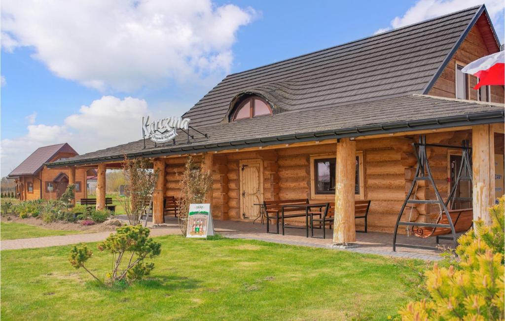 a log cabin with a picnic table in front of it at Stunning Home In Jezierzany With Outdoor Swimming Pool, Jacuzzi And 1 Bedrooms in Jezierzany