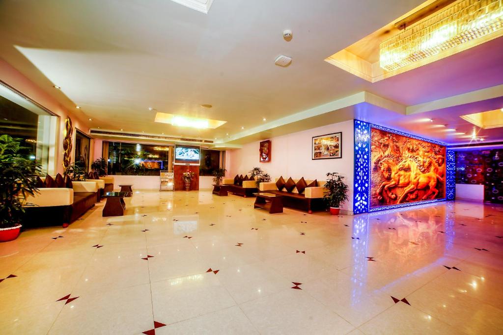 a large lobby with couches and tables in a building at THE FAME HOTEL in Jādabpur