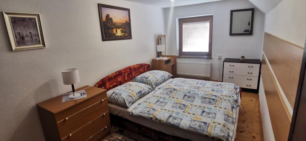 a small bedroom with a bed and a dresser at Vilka Stefi in Ždiar