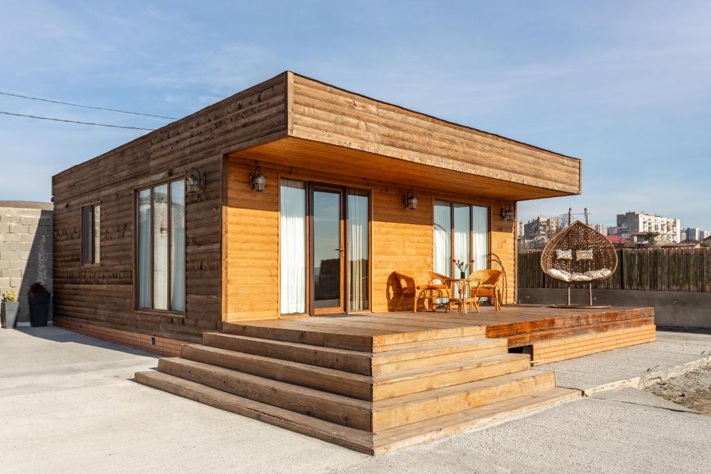 a tiny house with a deck on a roof at Eco house villa jeo in Tbilisi City