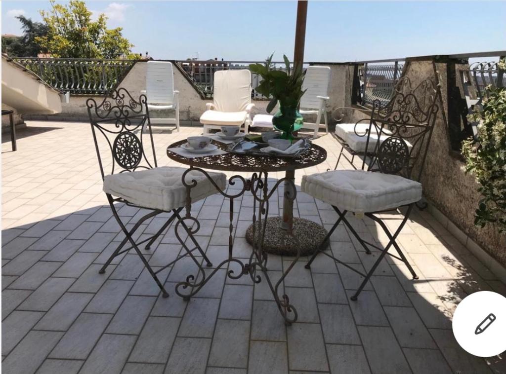 a table and four chairs on a patio at Villa Massimo in Albano Laziale