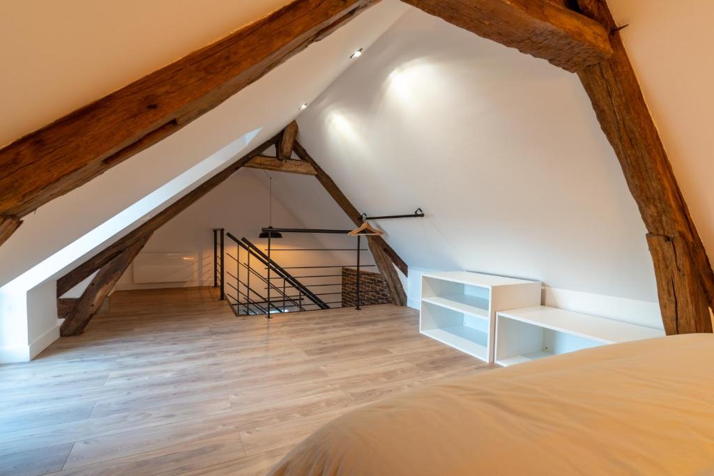 a loft conversion with a staircase and a bed at L&#39;Orée du Faubourg - VENDOME CENTRE in Vendôme