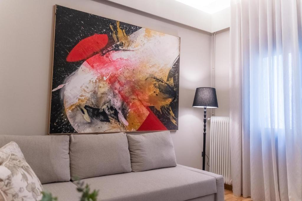 a painting on the wall of a living room with a couch at AN&VI Boutique Apartments Apt201 in Ioannina