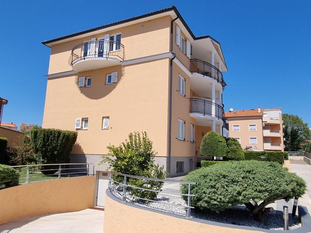 a tall building with bushes in front of it at Apartments Medulin - Orijeta in Medulin