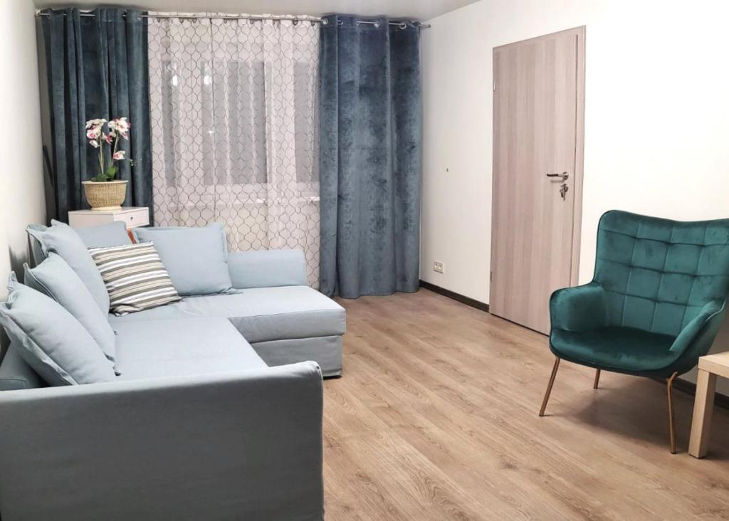 a living room with a couch and a chair at Apartment near Akropolis in Klaipėda