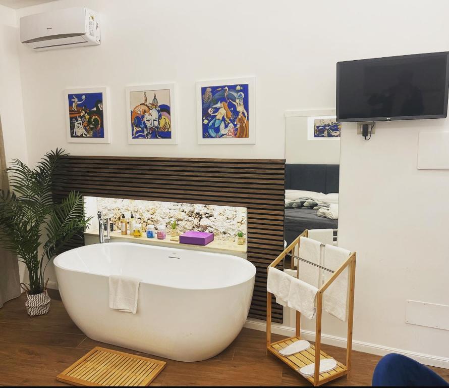 a bathroom with a white bath tub in a room at B&B Vietri Centro 2 in Vietri sul Mare