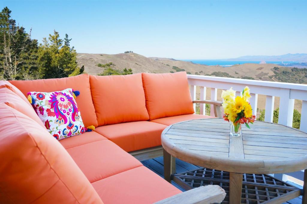 a couch and a table on a balcony at Mountain Top - Best View in SLO in San Luis Obispo