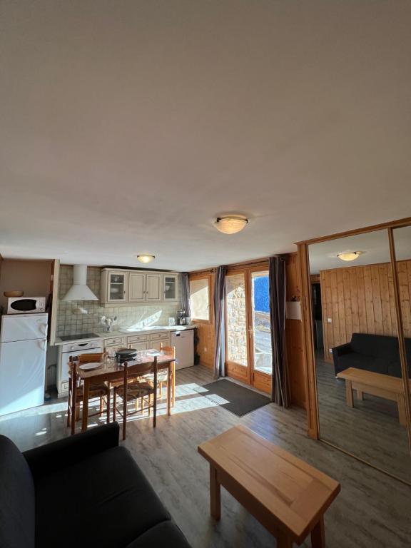 a living room with a couch and a table at Chalet Baptiste in Orcières