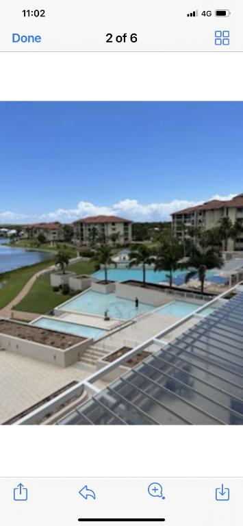 a screenshot of a picture of a building with two pools at Pelican Waters Resort One Bedroom Apartment in Pelican Waters