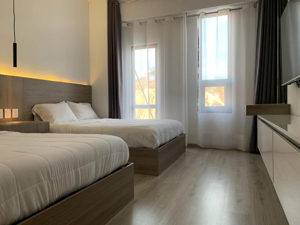 Postel nebo postele na pokoji v ubytování Hotel Blanco Pachuca