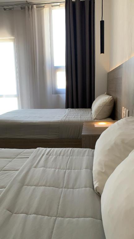 Postel nebo postele na pokoji v ubytování Hotel Blanco Pachuca