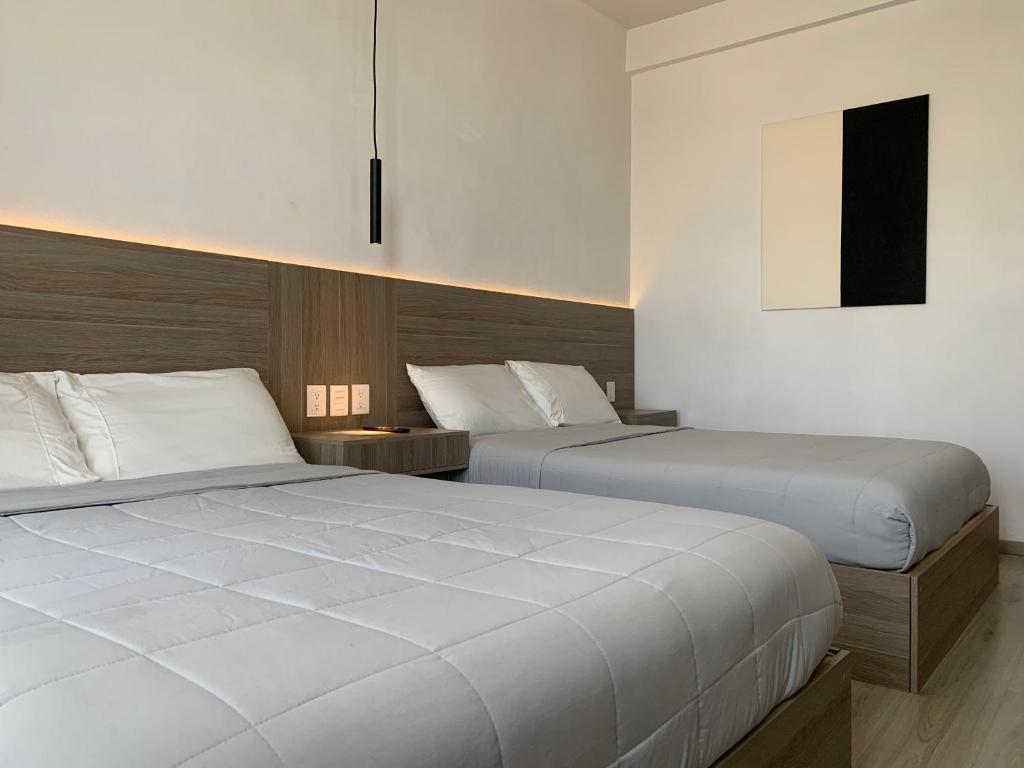 Postel nebo postele na pokoji v ubytování Hotel Blanco Pachuca