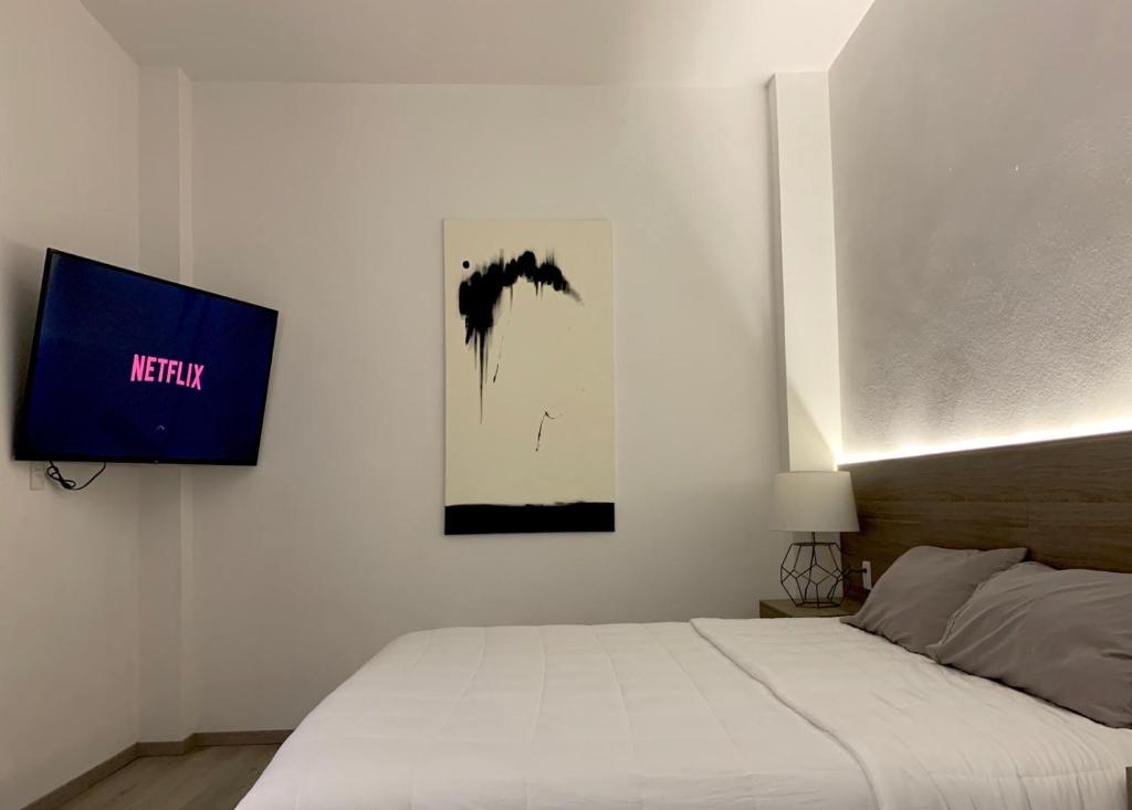 Postel nebo postele na pokoji v ubytování Hotel Blanco Pachuca