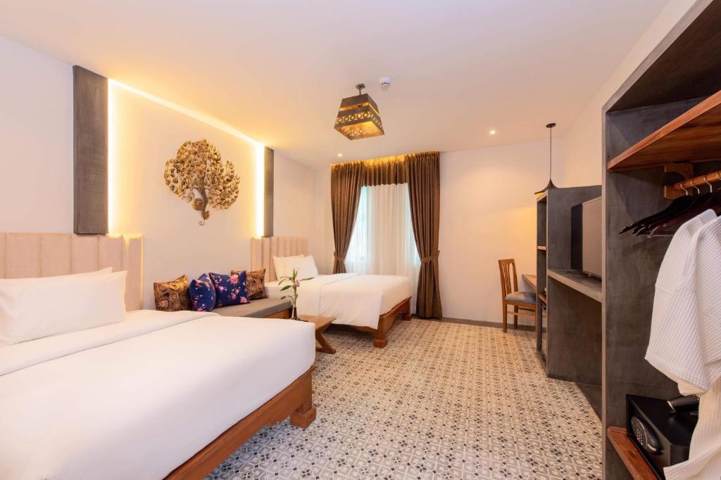 Postel nebo postele na pokoji v ubytování Siem Reap Palace Hotel & Spa