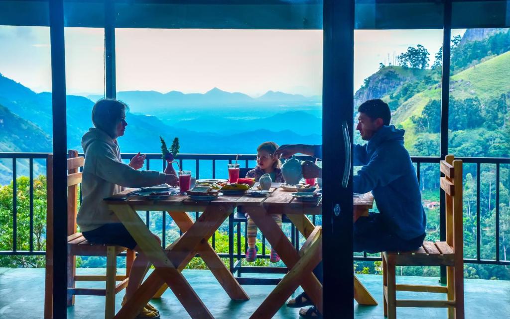 a group of people sitting at a table in a restaurant at Onestar Ella in Ella