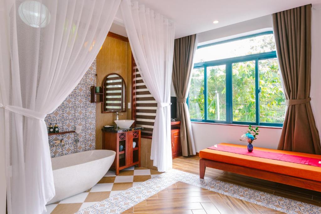 Postel nebo postele na pokoji v ubytování De'Colore Villa Hoi An