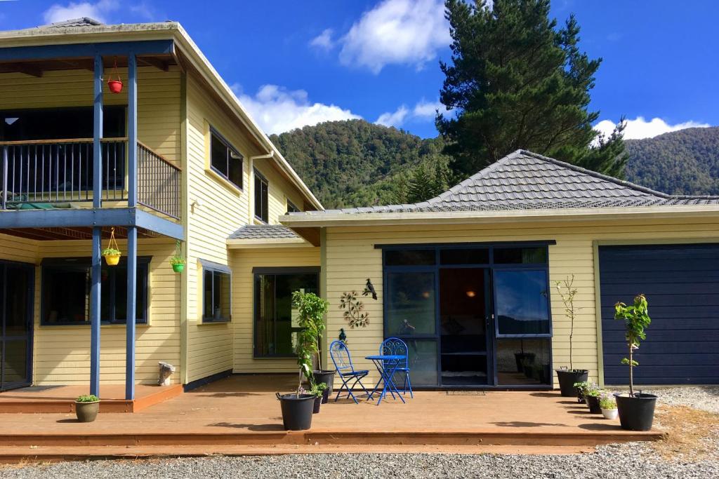 a house with a porch and a patio at Off the Beaten Track B&B in Canvastown