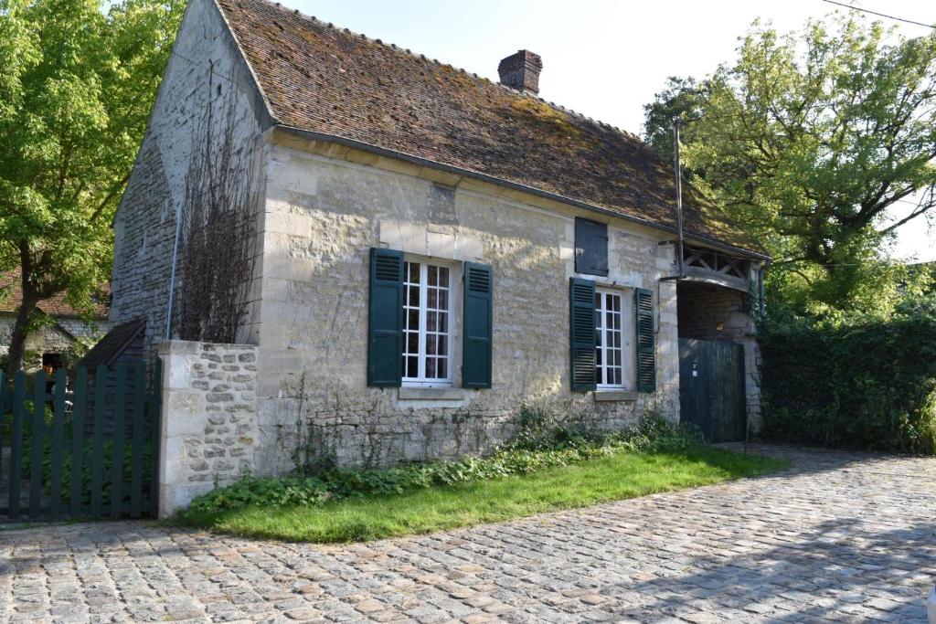 an old stone house on a cobblestone street at gite d'Albertine in Ully-Saint-Georges