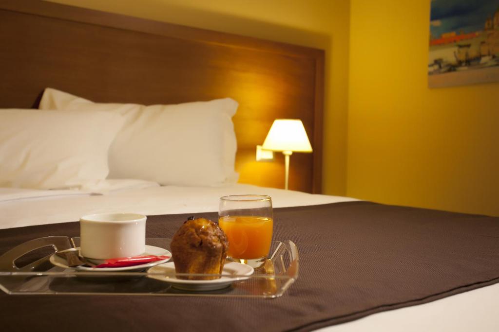 Łóżko lub łóżka w pokoju w obiekcie Hotel Tiziano