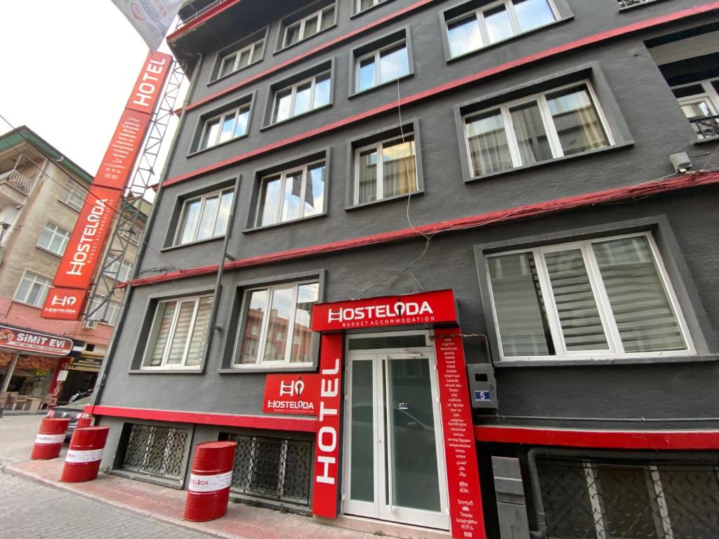 a black and red building with a red door at Hostelida Konya in Konya