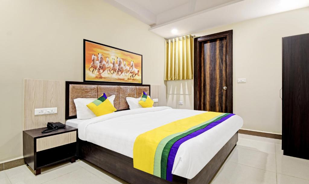 a bedroom with a large bed with a colorful blanket at Itsy By Treebo - Shashwat in Gorakhpur