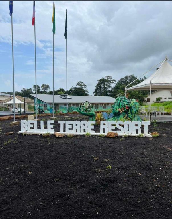 a sign for a blue terror resort in front of a building at Hôtel Belle Terre Resort in Macouria