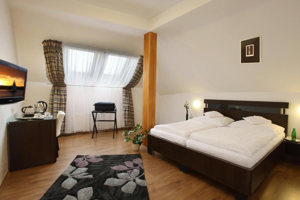 Postel nebo postele na pokoji v ubytování Hotel Trinity