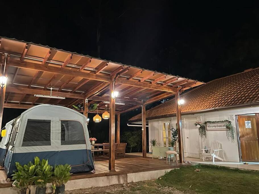 a tent sitting on a deck next to a house at Private Homestay with 2 bedroom and comfort tent in Bentong