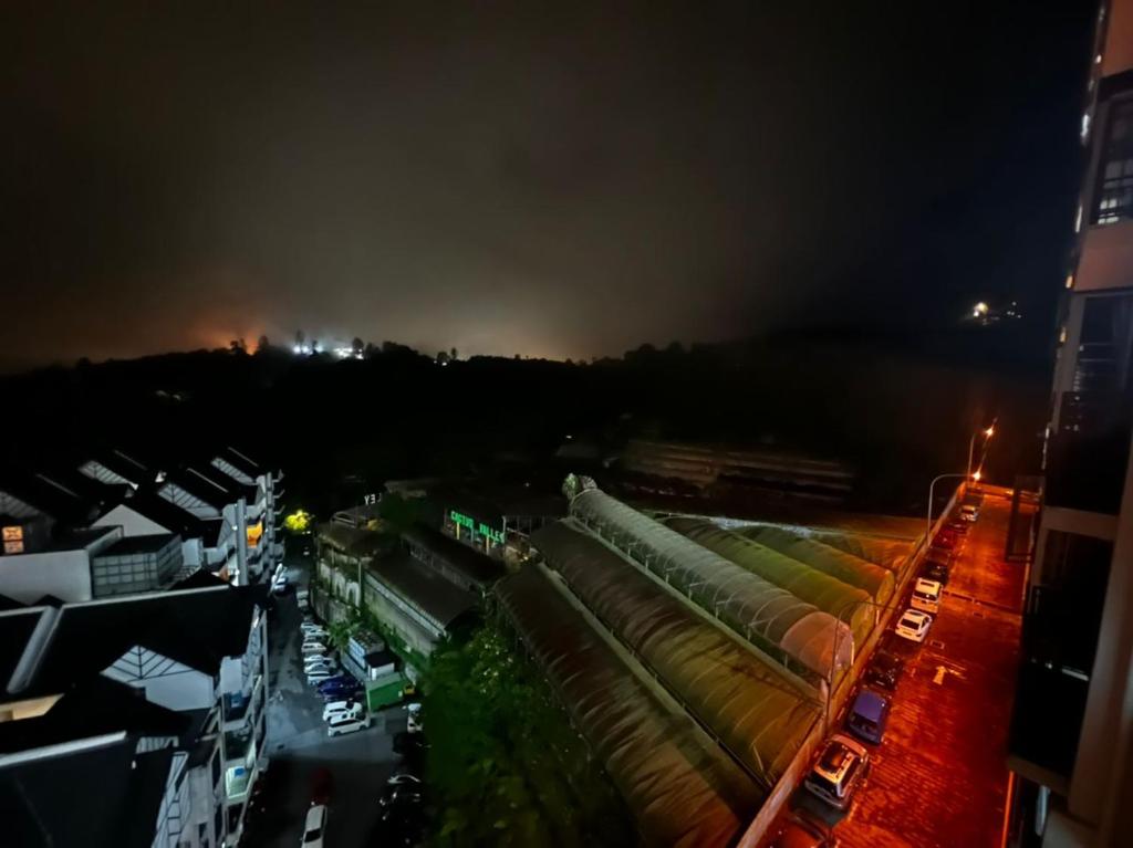 a view of a city at night with buildings at StoberiCekelatHomestaymuslim's in Brinchang