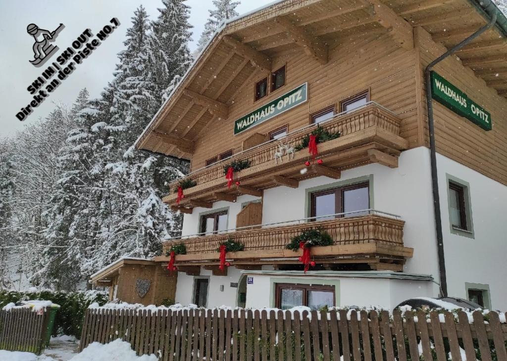 a building with a balcony with christmas decorations at Apartment Waldhaus Opitz in Zell am See