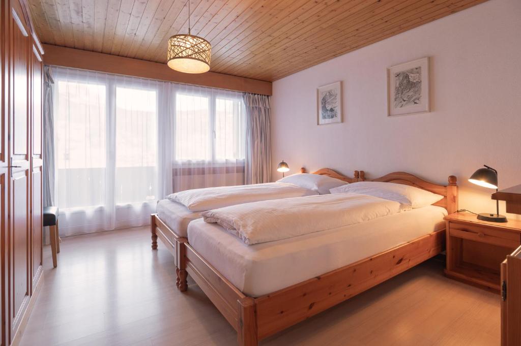 Posteľ alebo postele v izbe v ubytovaní Apartment Jungfrau Lodge