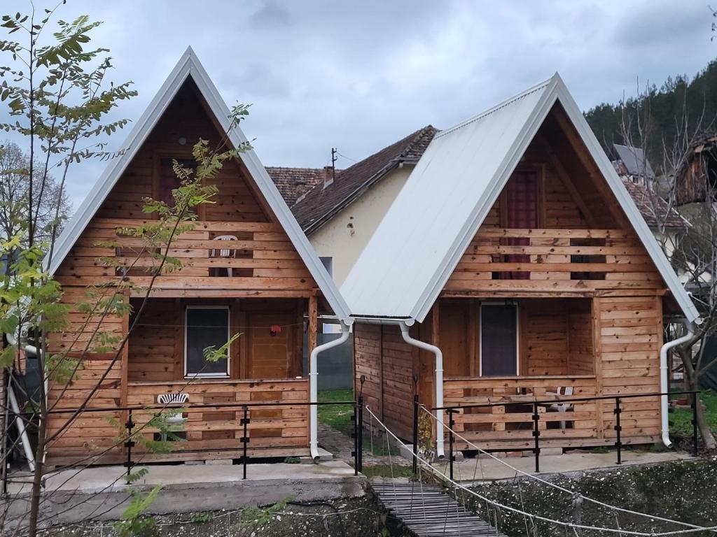 a log cabin with a metal roof at Kamp Bungalovi Sase drvena kuca in Višegrad