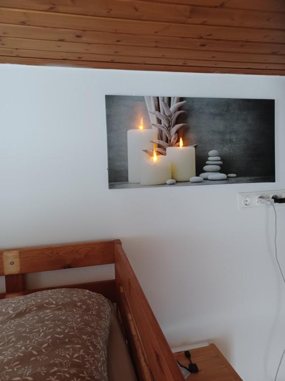 a room with two candles on a shelf with a bed at Seidis Apartment mit Küche 
