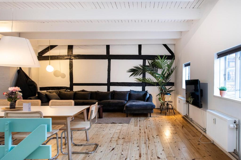 a living room with a couch and a table at The Townhouse by Daniel&Jacob's in Copenhagen